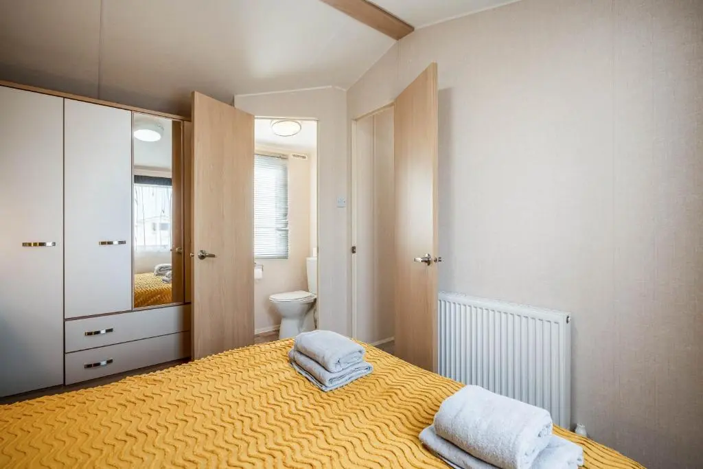 a bedroom with a bed with two towels on it at Lyons Retreat in Lossiemouth