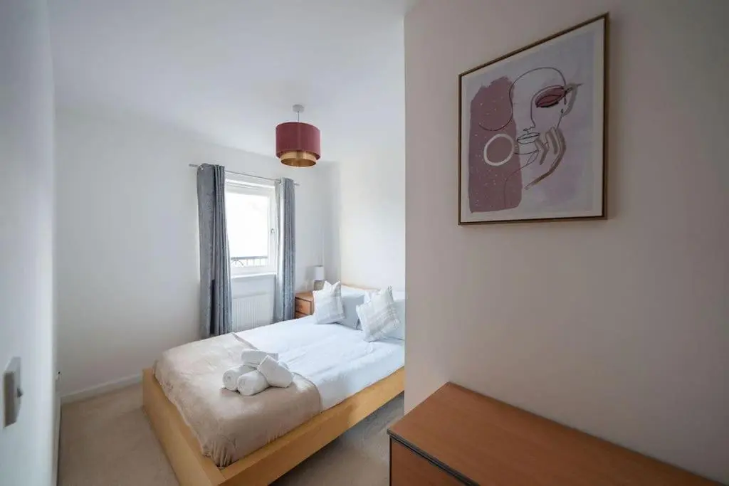 a bedroom with a bed and a picture on the wall at Hope House - 2 bedroom flat in Aberdeen