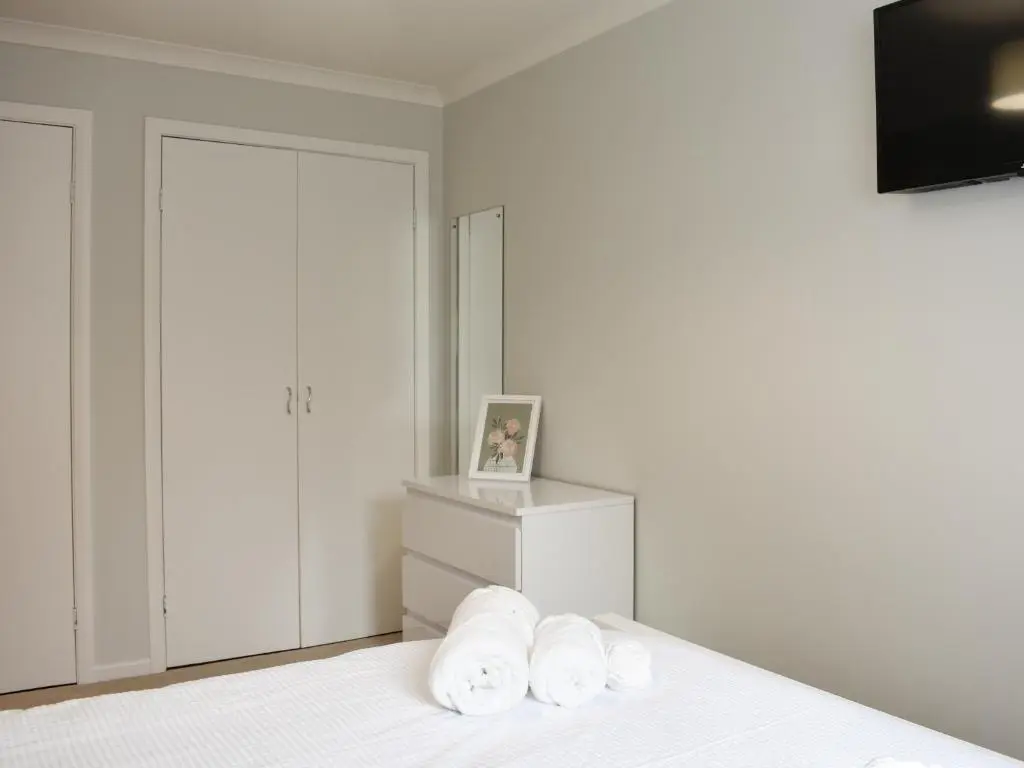 a bedroom with a bed with two white towels at Cathwill in Newtonmore