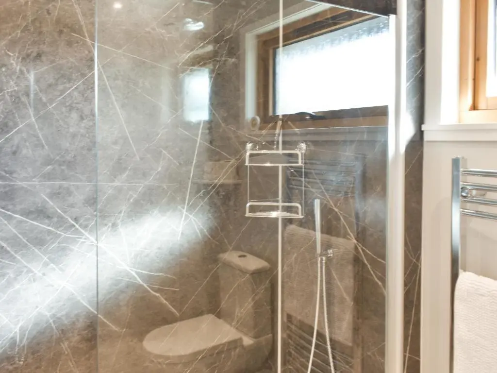 a bathroom with a glass shower with a toilet at Cathwill in Newtonmore