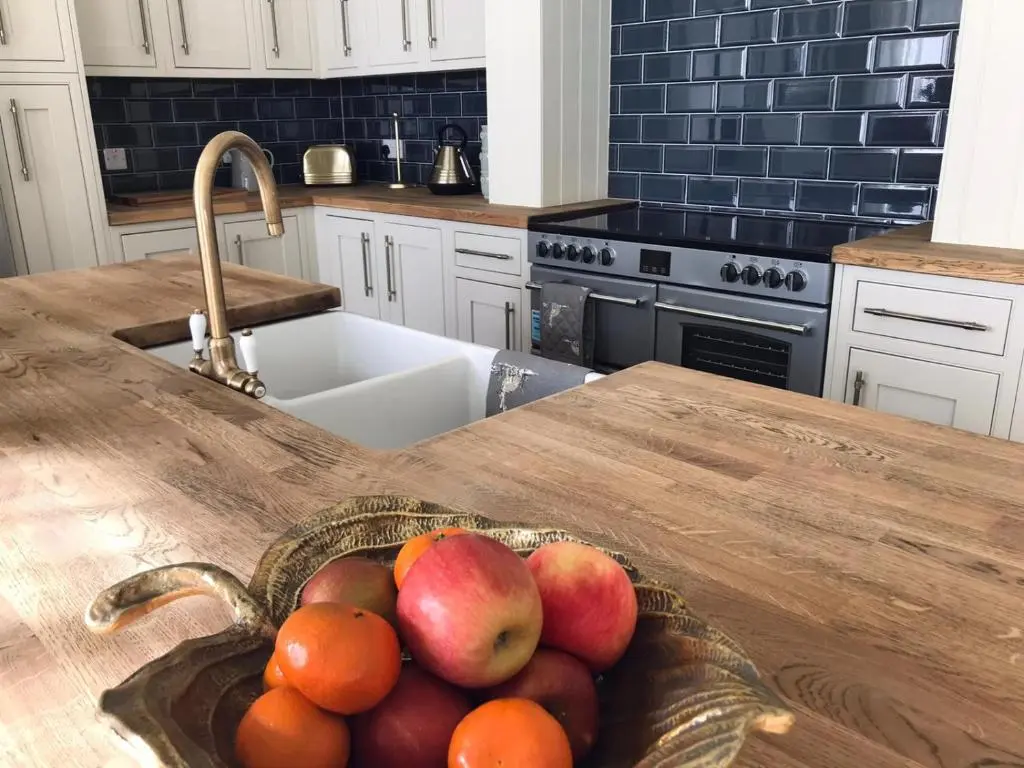 a bowl of apples and oranges on a kitchen counter at Gardeners cottage in Pitlochry