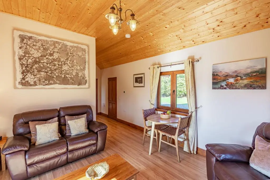 a living room with a couch and a table at Wildcat Lodge in Cray