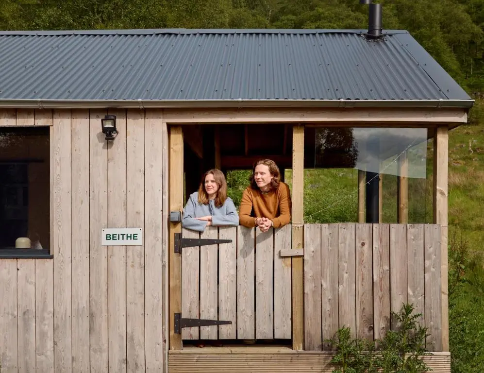 two women looking out of the window of a smallshed at The Dell at Glenlivet in Glenlivet