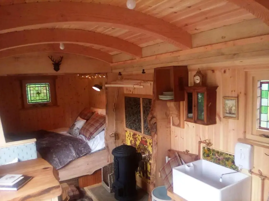 a tiny house with a sink and a bedroom at Holiday Home Shepherds Hut by Interhome in Bearnock
