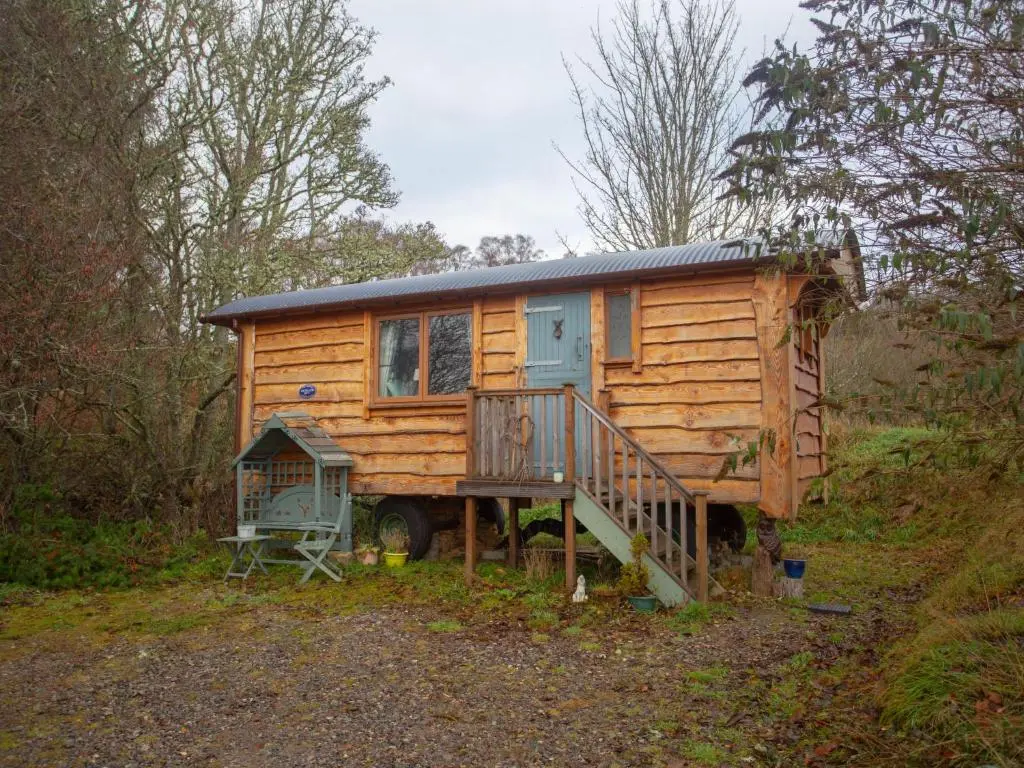 a wooden tiny house sitting on top of a hill at Holiday Home Shepherds Hut by Interhome in Bearnock