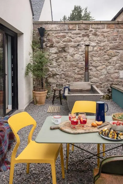 a table and two chairs with food on a patio at Number 2 Steading Cottage in Banchory