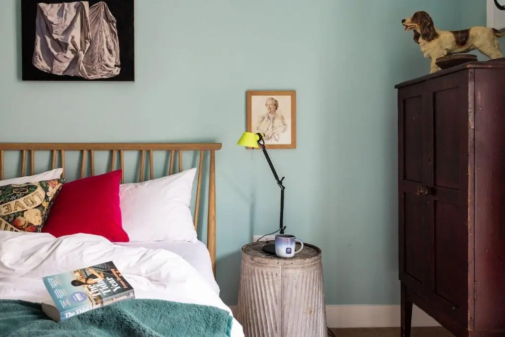 a bedroom with a bed with a lamp and a dresser at Number 2 Steading Cottage in Banchory