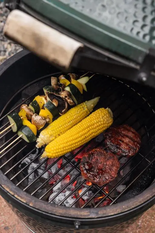 a grill with corn and a hamburger on it at Number 2 Steading Cottage in Banchory