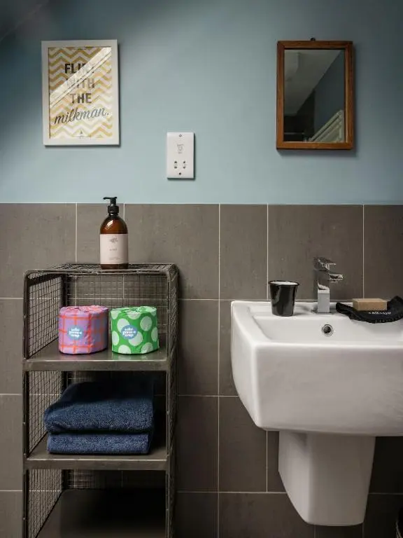 a bathroom with a sink and a mirror and towels at Number 4 Steading Cottage in Banchory