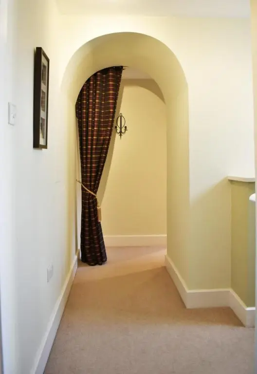 a hallway with a curtain in a room at The Ross 2 bedroom apartment in historic Abbey in Fort Augustus