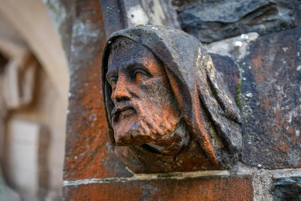 a statue of a man on a brick wall at Monastery apartment with Loch Ness view in Fort Augustus