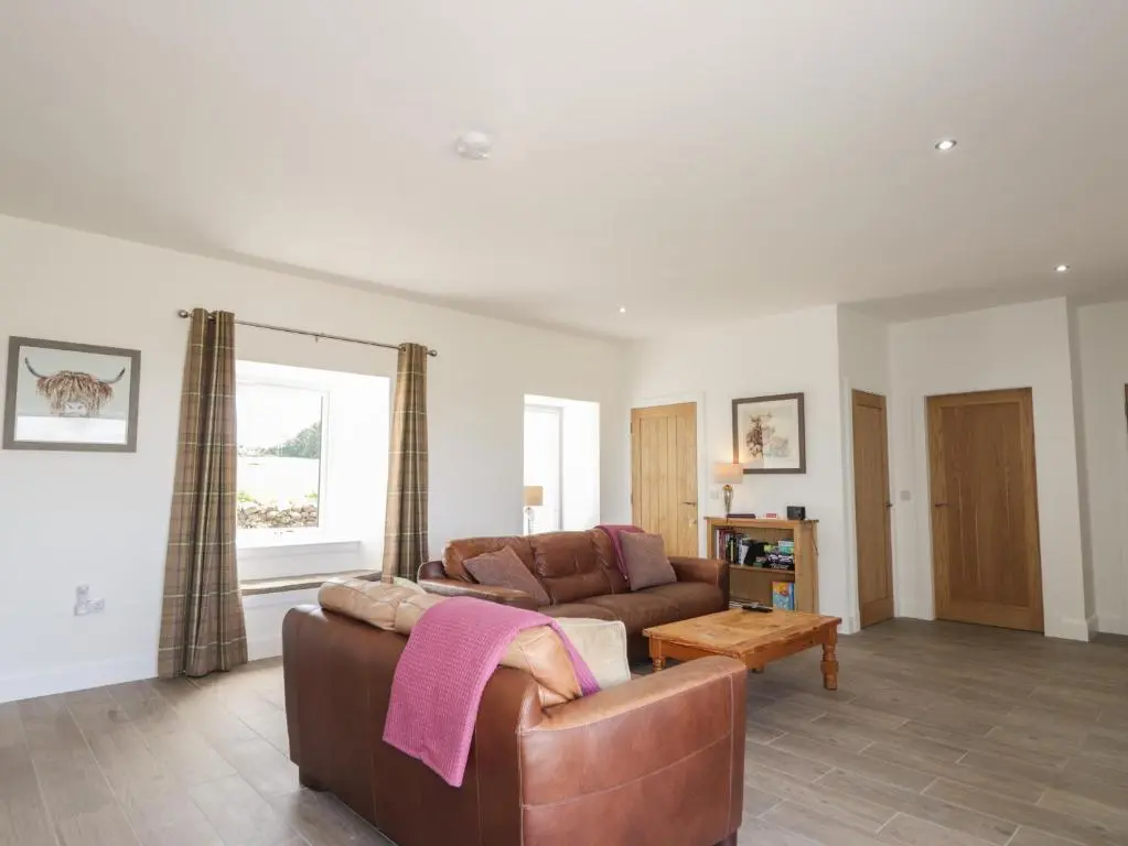 a living room with a couch and a table at Firthview in Nairn