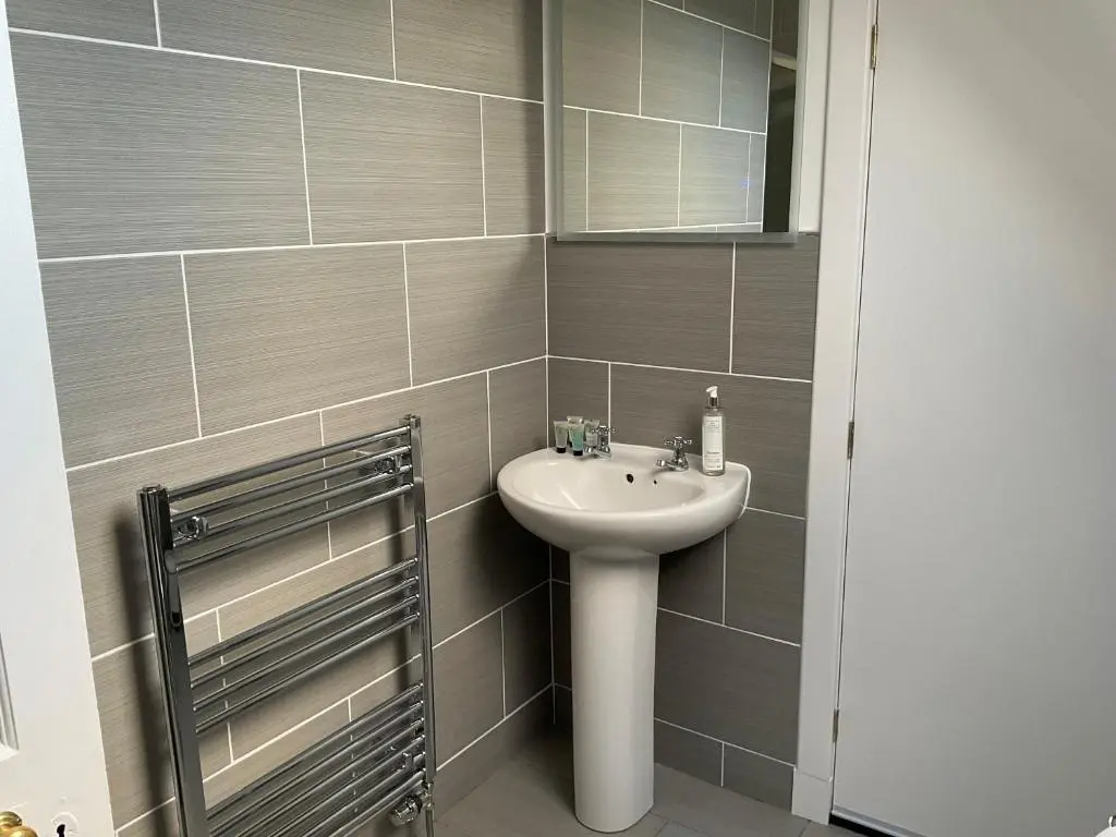 a bathroom with a sink and a mirror at Glenshee Guest House in Golspie