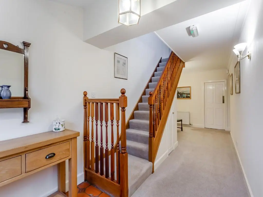 a staircase in a home with white walls at Cruives Lodge in Kiltarlty