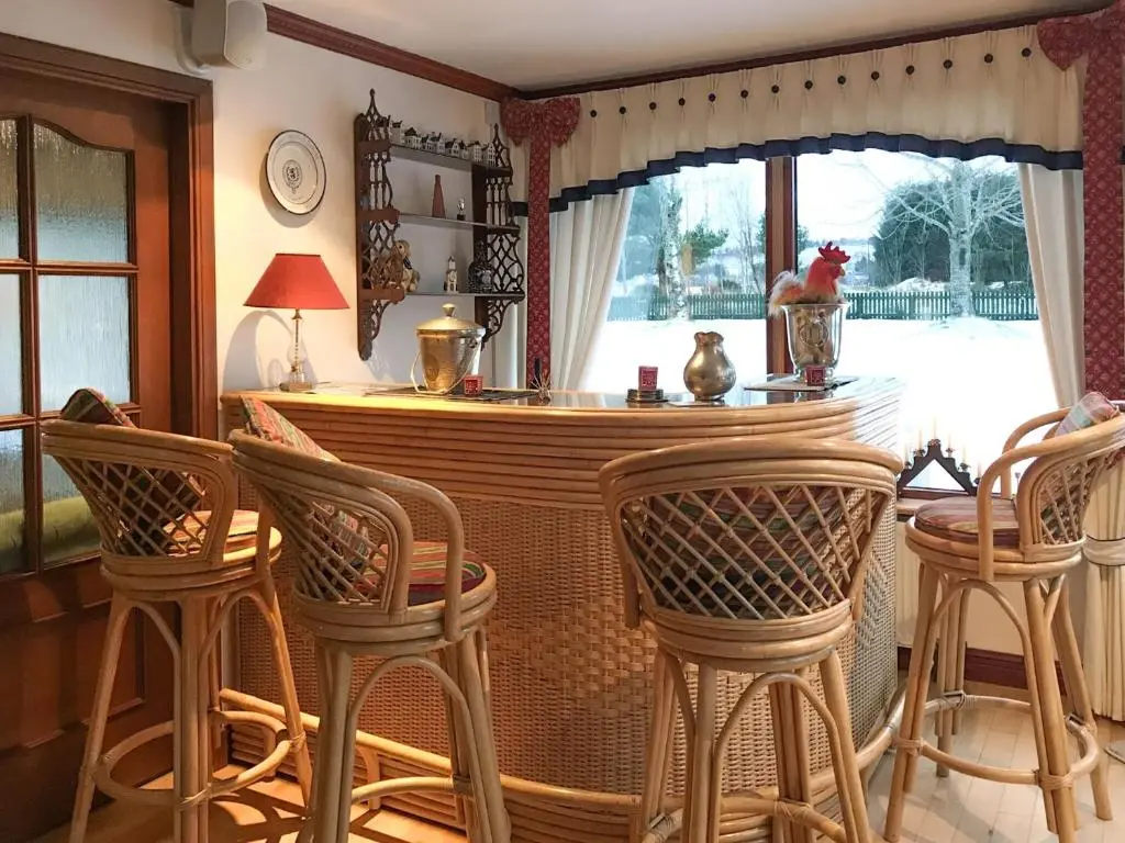 a kitchen with a bar with chairs and a window at Scardroy Alford in Alford