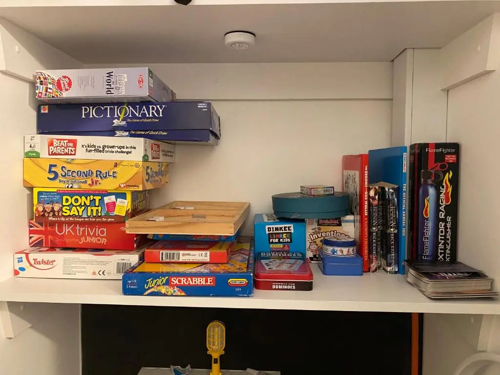 a shelf filled with books and other books at Hiltula spacious premium apartment with beautiful views in Inverness
