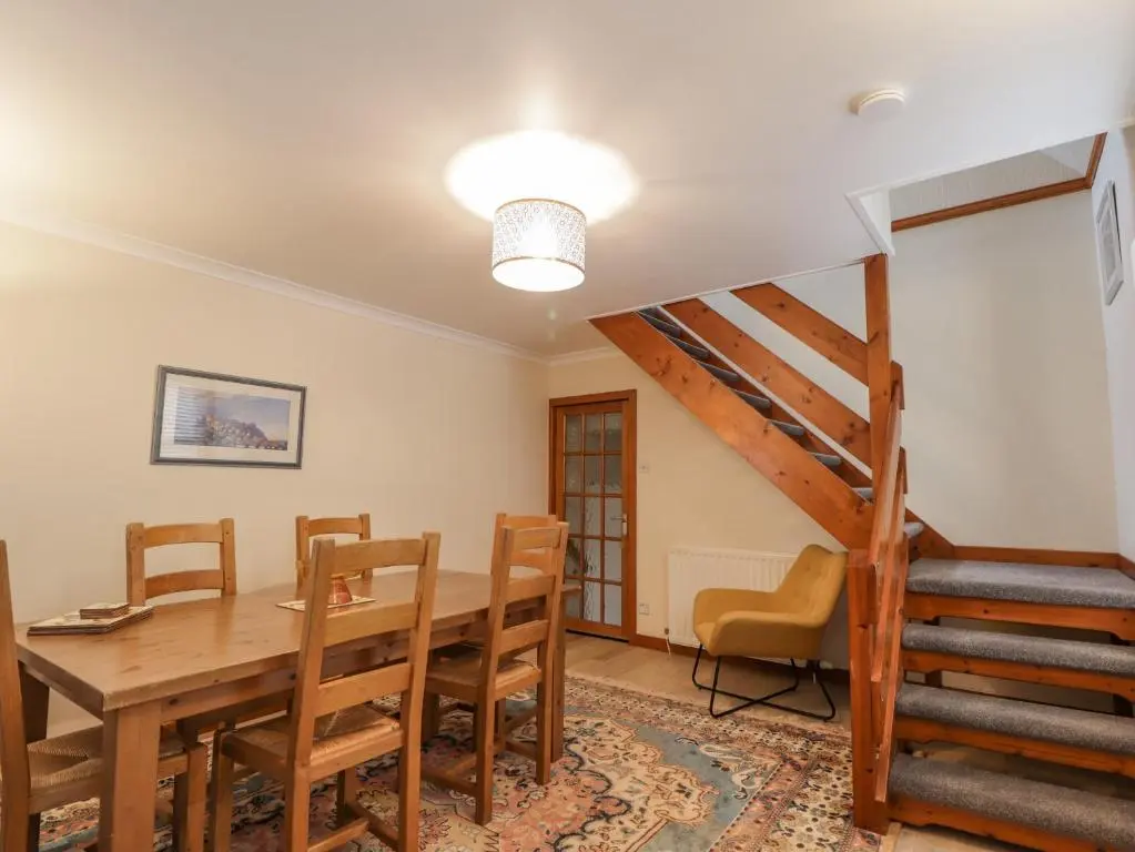 a dining room with a wooden table and chairs at 20 South High Street in Portsoy