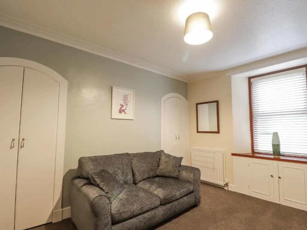 a living room with a couch and a window at 20 South High Street in Portsoy