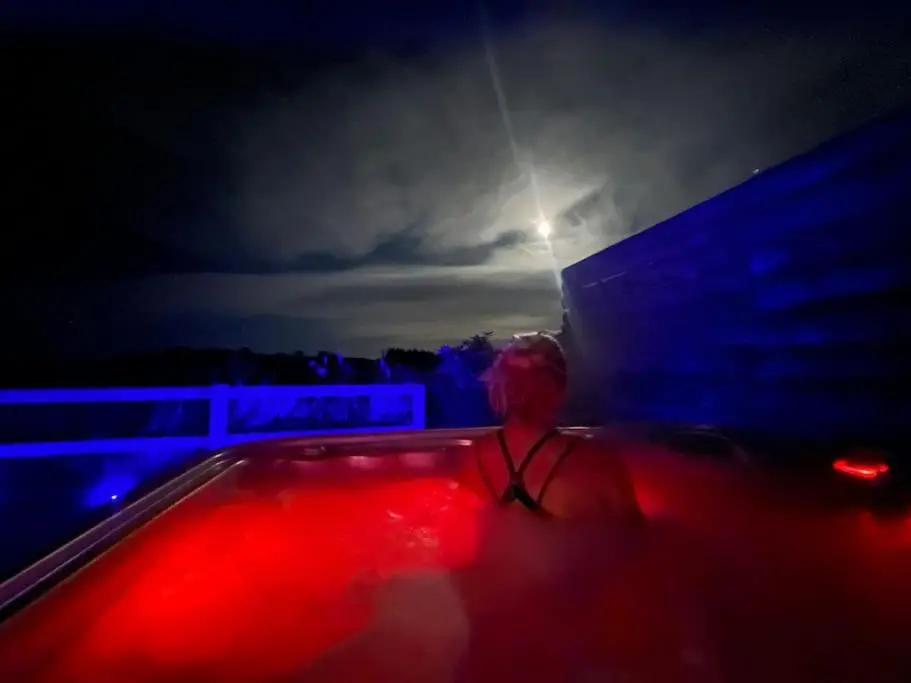 a man standing in a pool at night at Osprey Hide in Forres