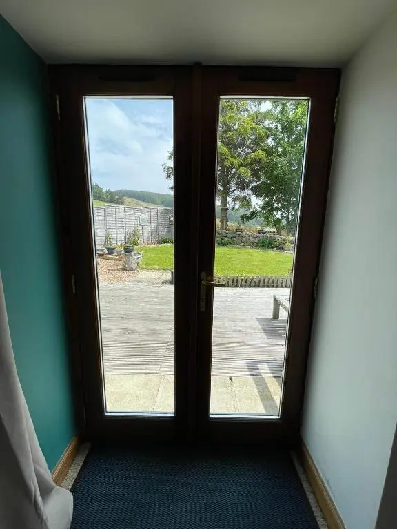 an open door with a view of a yard at Barclay\u2019s But n Ben in Alford