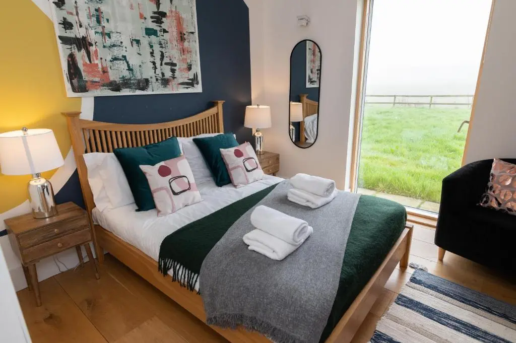 a bedroom with a bed with towels on it at A Stunning State Of The Art Eco Home - Games Room in Westhill