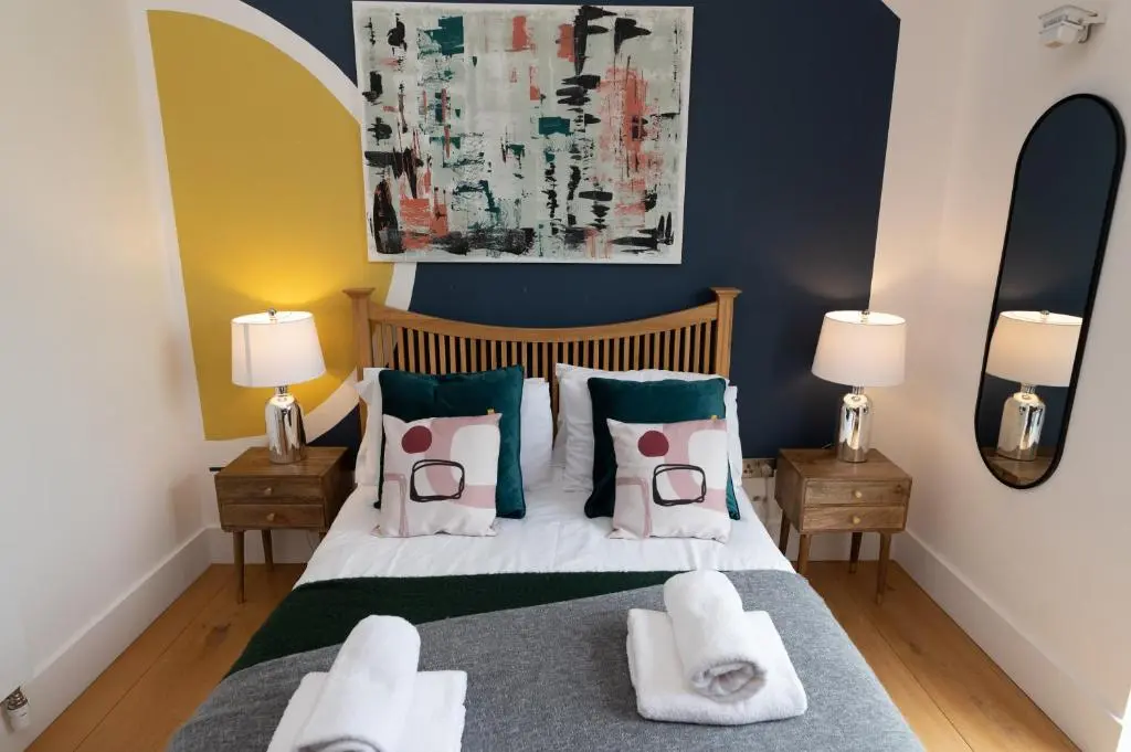 a bedroom with a bed with towels on it at A Stunning State Of The Art Eco Home - Games Room in Westhill
