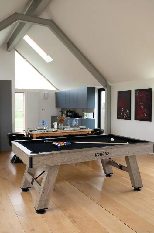 a pool table in the middle of a room at A Stunning State Of The Art Eco Home - Games Room in Westhill
