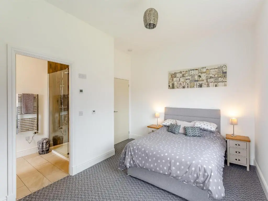 a bedroom with a bed and a mirror at Old School House in Altnaharra