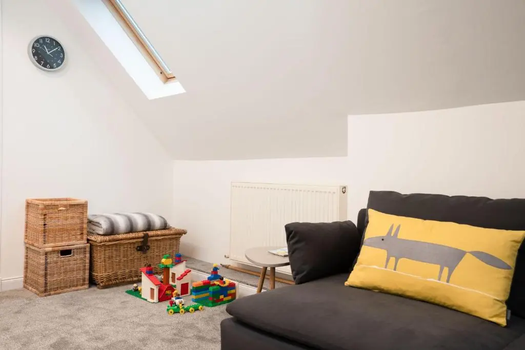 a living room with a couch and a table at The Wilds - Seasgair Lodges in Kingussie