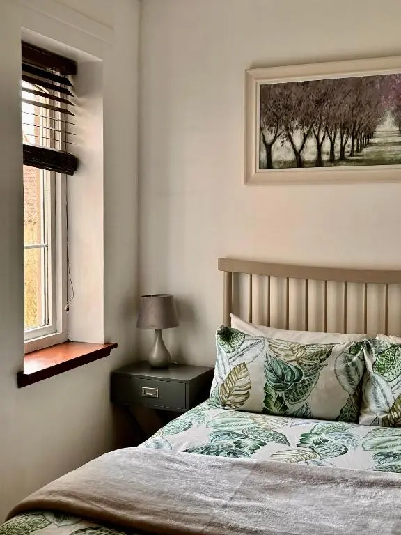 a bedroom with a bed and a window at Apartment with parking, close to the Raigmore hospital in Inverness