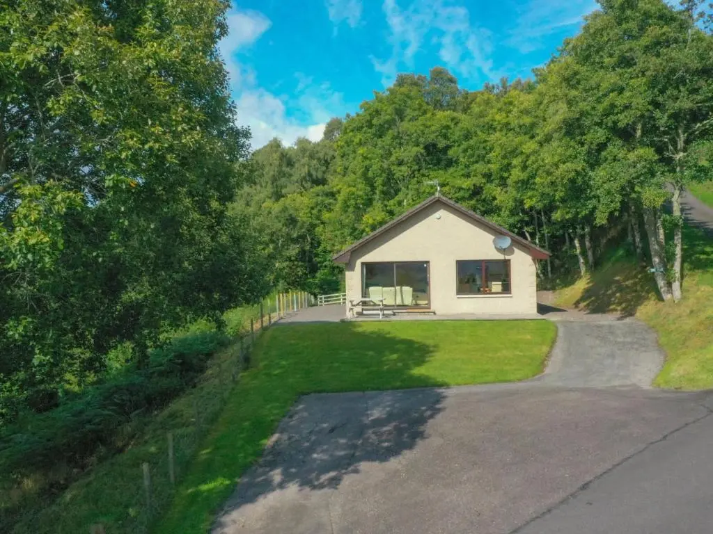 a small white house with a driveway at Holiday Home Achmony Byre by Interhome in Drumnadrochit