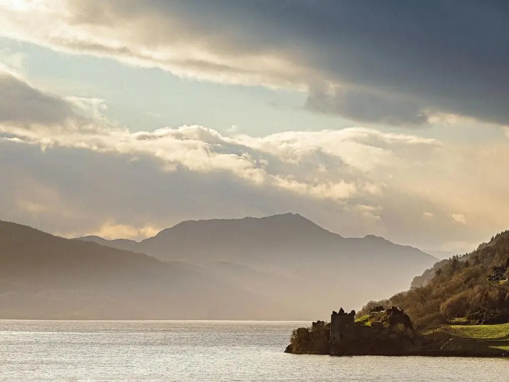 a castle in the middle of a body of water at Holiday Home Achmony Number 7 by Interhome in Drumnadrochit