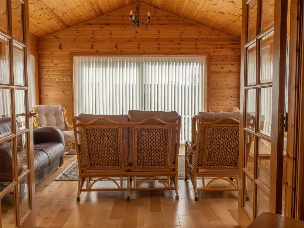 a living room with two chairs and a couch at Holiday Home Achmony Number 7 by Interhome in Drumnadrochit