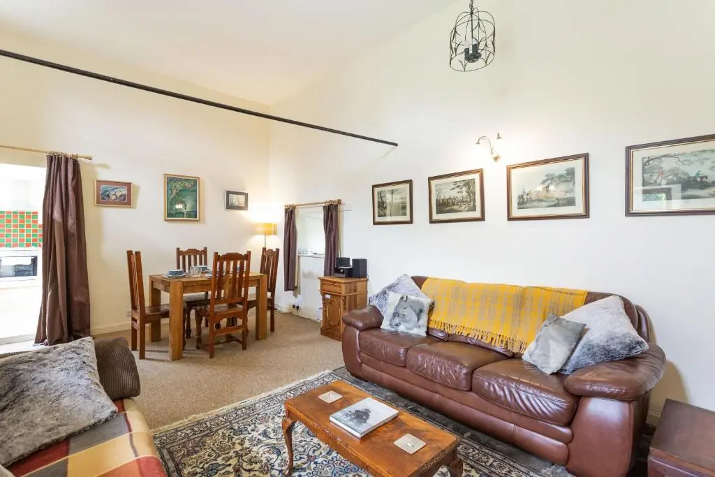 a living room with a couch and a table at The Old Mill in Beauly