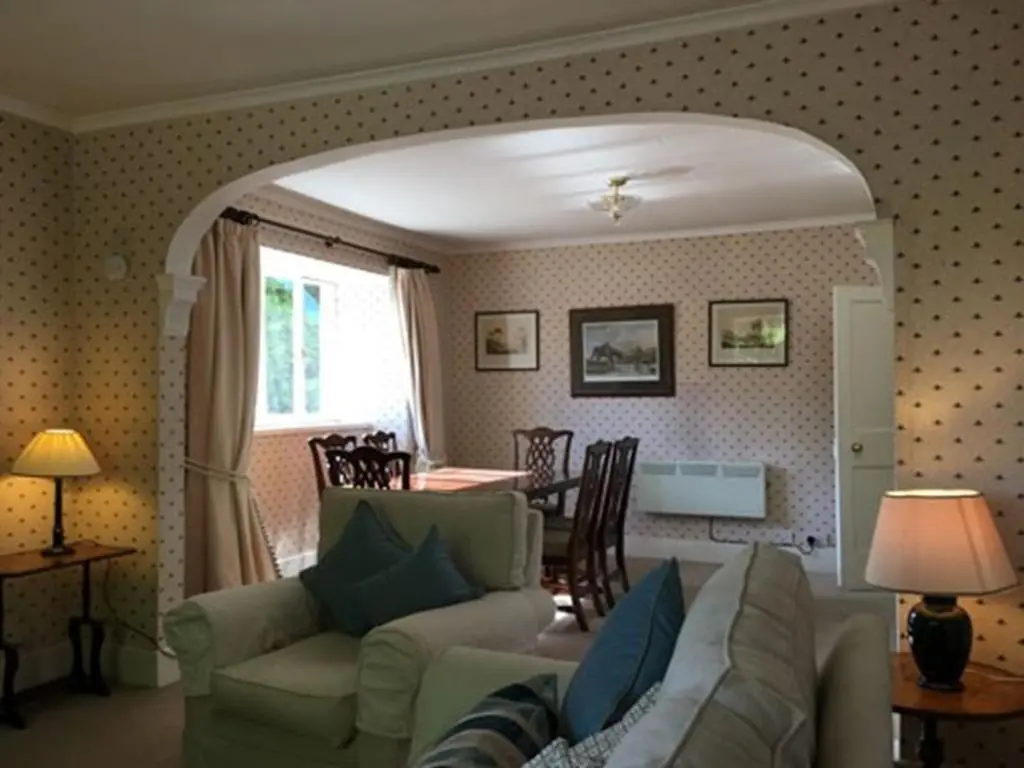 a living room with a couch and a table at The Delnashaugh in Ballindalloch
