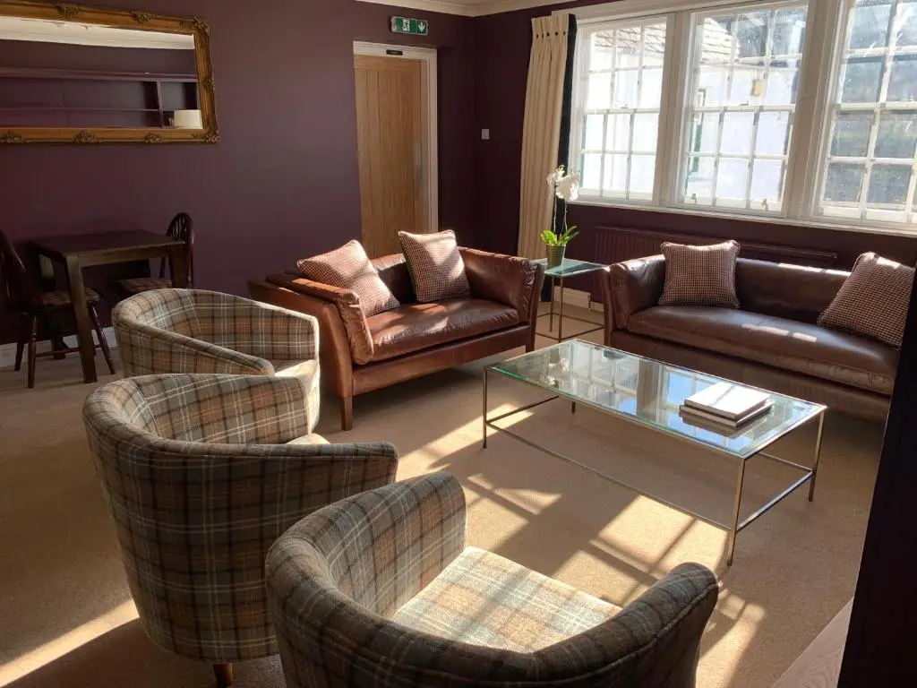 a living room with a couch and chairs and a table at The Delnashaugh in Ballindalloch