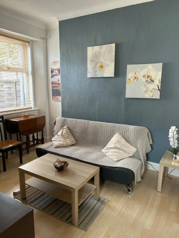 a living room with a couch and a table at Rosebery apartment-Inverness in Inverness