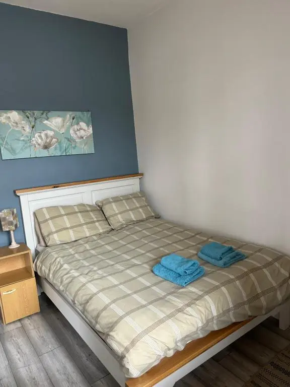 a bed with two towels on it in a room at Rosebery apartment-Inverness in Inverness