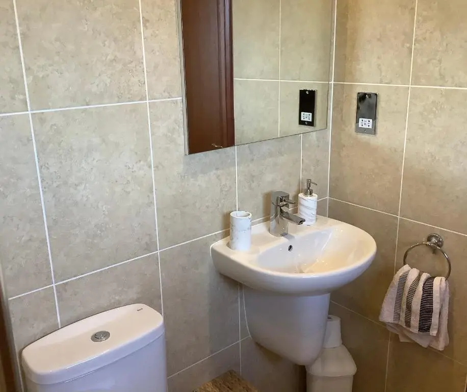 a bathroom with a sink and a toilet and a mirror at Bonny Vista in Inverness