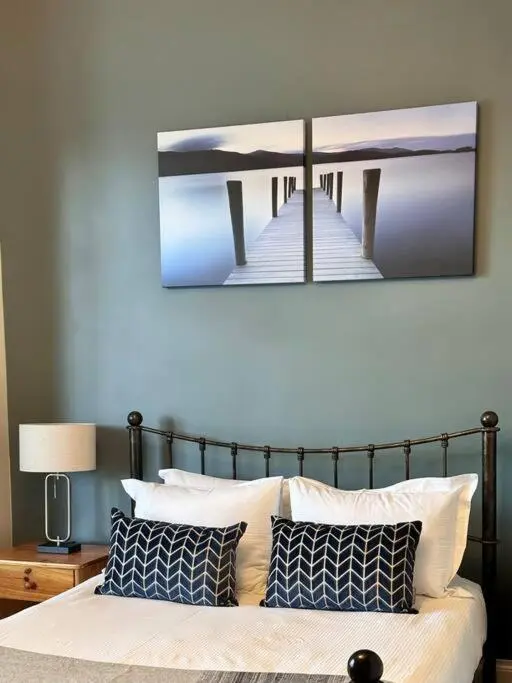 a picture of a pier above a bed with pillows at Home Sweet Home, Central in Inverness