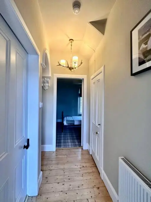 a hallway with a hallway leading to a bedroom at Home Sweet Home, Central in Inverness