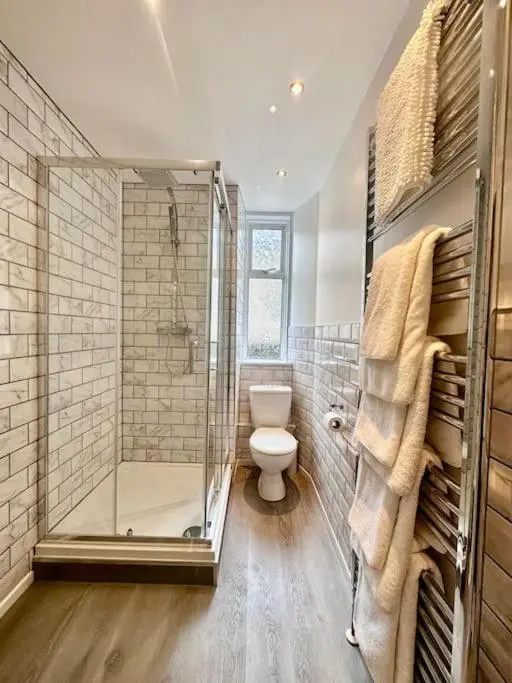 a bathroom with a glass shower and a toilet at Home Sweet Home, Central in Inverness