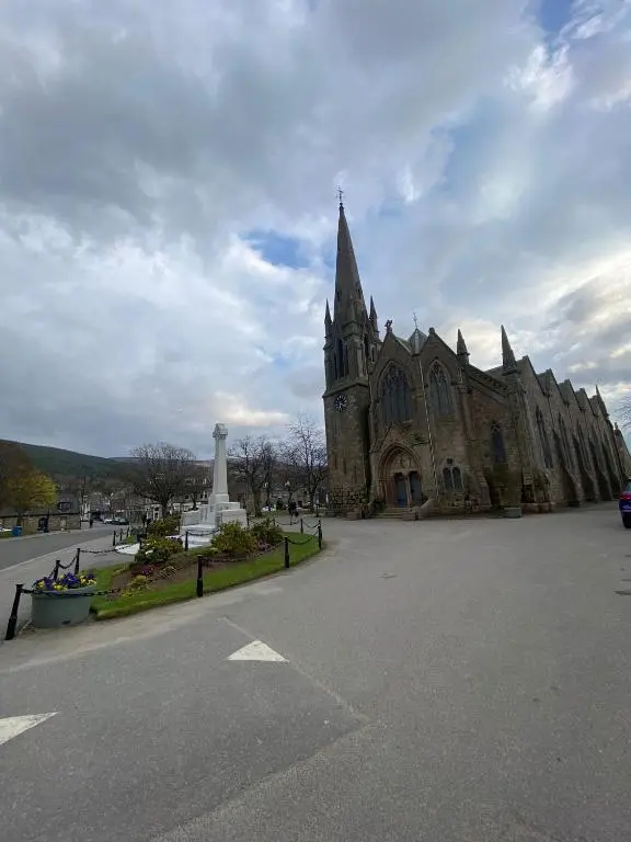 a church with a monument in front of it at 1 Golf Mews in Ballater