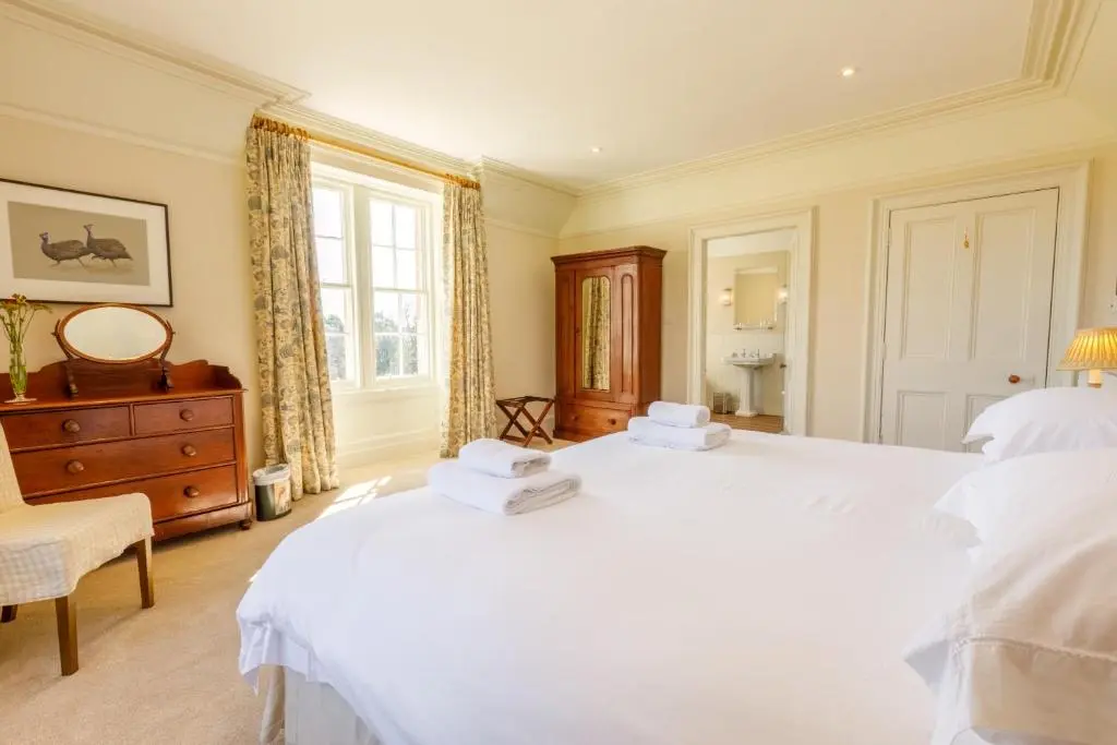 a bedroom with two white beds and a window at Dalgheal in Evanton