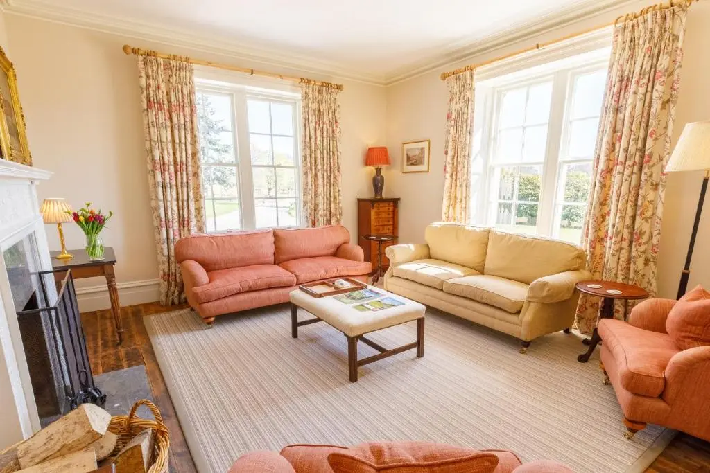 a living room with two couches and a fireplace at Dalgheal in Evanton