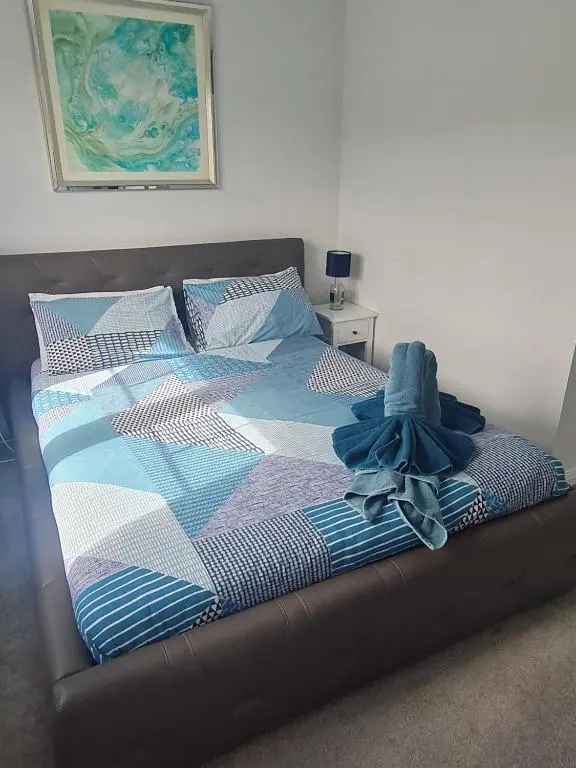 a bed with a blanket and a pair of shoes on it at Faillie in Inverness