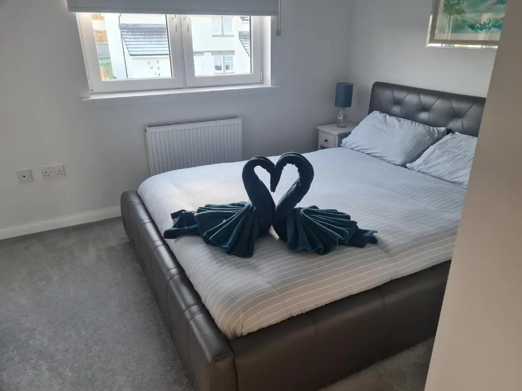a bed with two bows on it in a bedroom at Faillie in Inverness