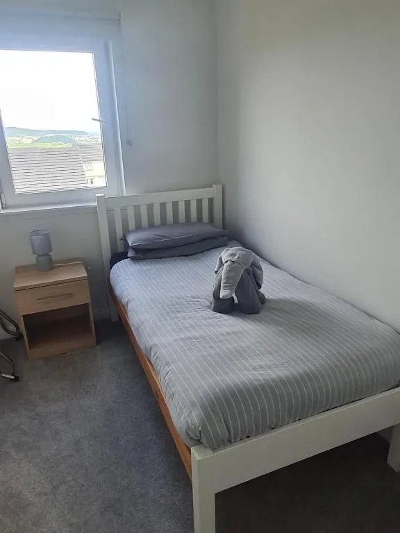 a bedroom with a bed with a backpack on it at Faillie in Inverness